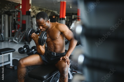 African American young man doing workout at the gym © Serhii
