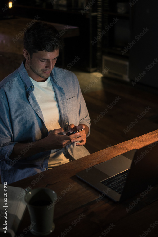 Young freelancer using smart phone in home office Young freelancer using smart phone in home office