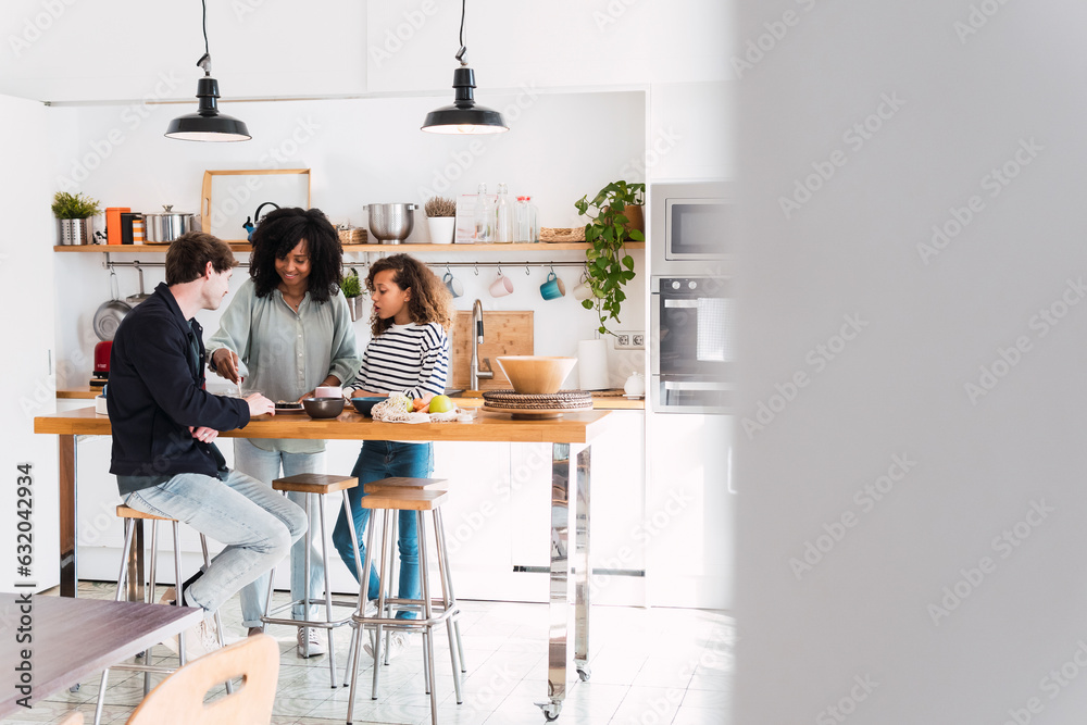Family in kitchen preparing food together