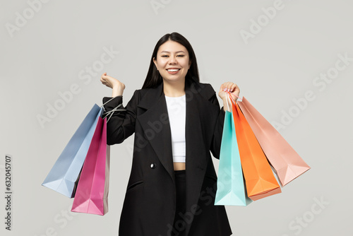 Girl of Asian appearance with paper bags for shopping
