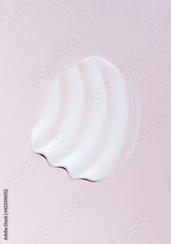 cosmetic smear cream texture on pastel pink background