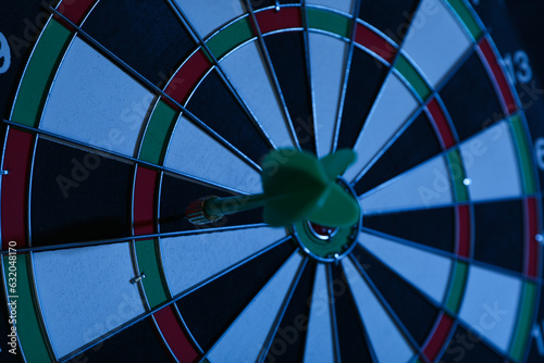 Darts, hitting the target, with wires, on a dark background.