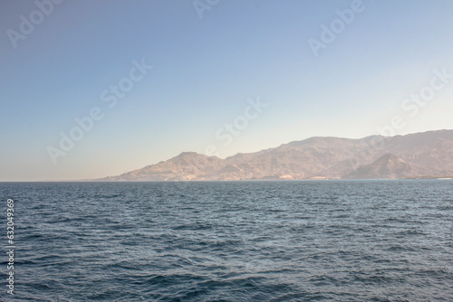 Red Sea Mountains on the horizon between the blue sky and the sea, Ain Sokhna, Suez, Egypt photo