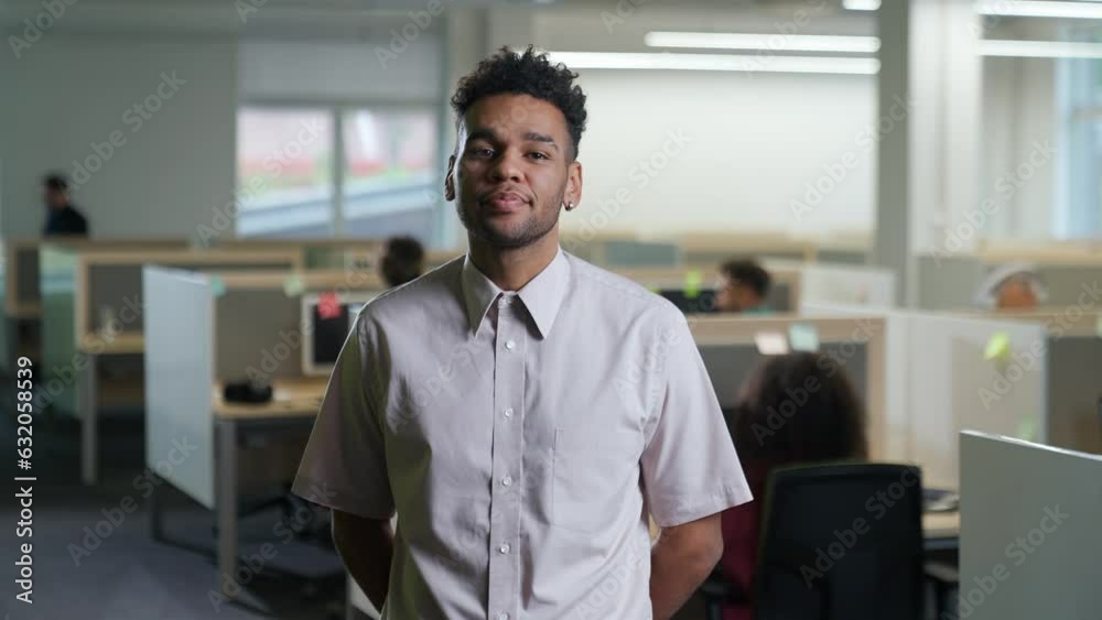 Portrait of a cheerful art director against the background of international office space, dark skinned man looks at the camera and smiles, open space. Portrait of a cheerful art director against the background of international office space, dark skinned man looks at the camera and smiles, open space.