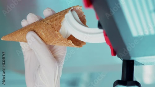 Close-up of filling a waffle cup with ice cream in slow motion photo