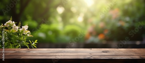 An outdoor garden background with a wooden table top that is empty and blurred. The wood table provides space for text, marketing promotions, or any other content. It is a blank space that can be