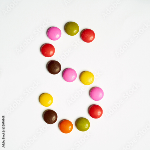 Letters written with multi colored chocolate candy 