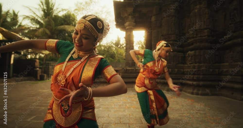 Slow Motion Portrait of Indian Women in Traditional Clothes Dancing Bharatanatyam in Colourful Sari . Close-up on Expressive Young Females Performing Folk Dance Choreography in an Ancient Temple