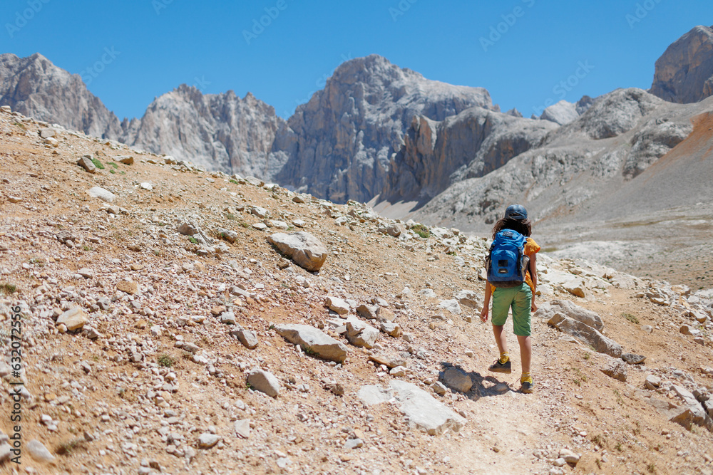 child travels in the mountains with a backpack. mountain hike in high mountains. Turkey. child travels in the mountains with a backpack. mountain hike in high mountains. Turkey.
