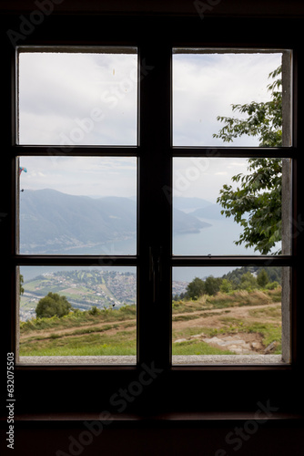 Detail of a separate window with six panes of glass against the light and Swiss nature can be seen outside