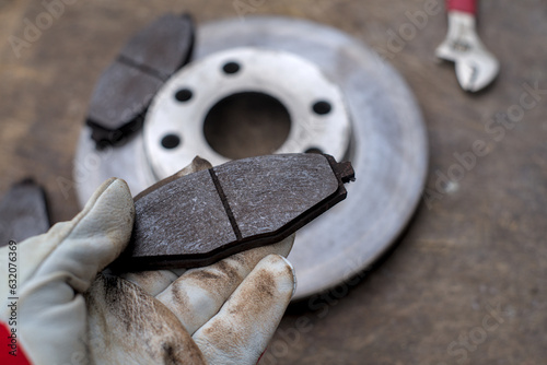 Car mechanic checking asbestos brake pads