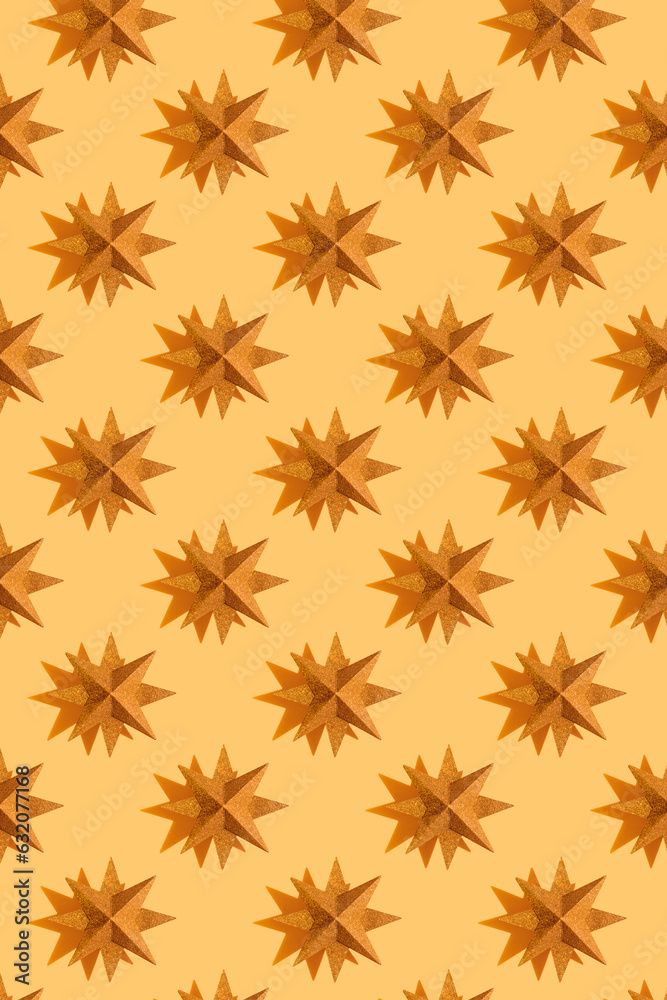 Glitter gold stars decoration pattern on beige background with shadows. Festive background. Winter minimal holiday postcard. New Year or Christmas minimal flat lay concept Glitter gold stars decoration pattern on beige background with shadows. Festive background. Winter minimal holiday postcard. New Year or Christmas minimal flat lay concept