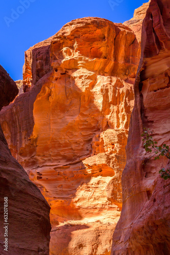 The Siq, narrow red canyon, rocks background in Petra, Jordan, UNESCO World Heritage Site