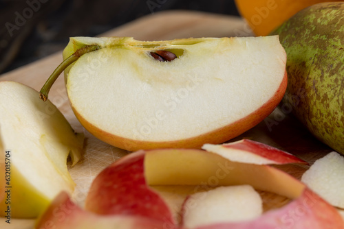 Peel and slice ripe red apples, close up photo