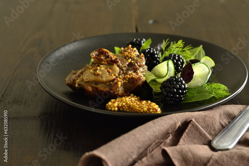 Roasted turkey thigh with green salad and blackberries, served with french mustard, copy space
