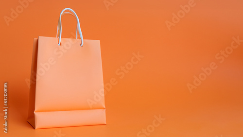 Orange shopping bag on orange background