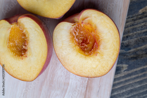 Ripe fresh peaches on a wooden table