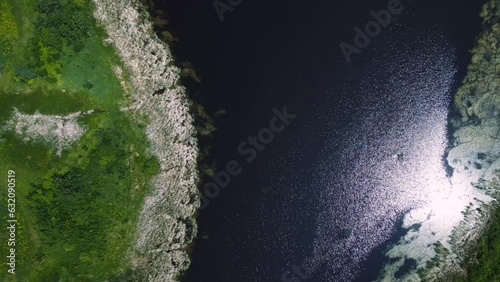Wallpaper Mural Drone Flies Down Shore of a Shimmering Summertime Grassy Riparian Blue Water Cattail Island Wetland on Outdoor Lake Habitat Farmland Park in Brandon Manitoba Canada Torontodigital.ca