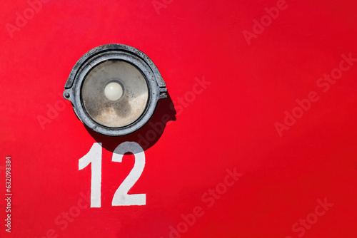 Old tram number 12. Lantern on a red background. Red background. Place for text. Copyspace.