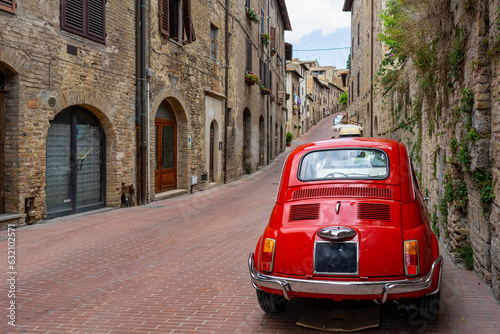 old nostalgia red car in the italy street, tuscany
