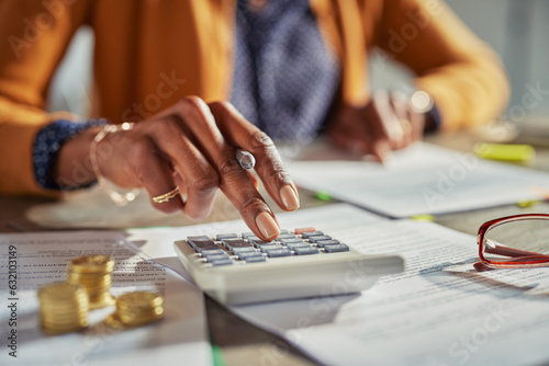 Black woman hand calculating taxes photo