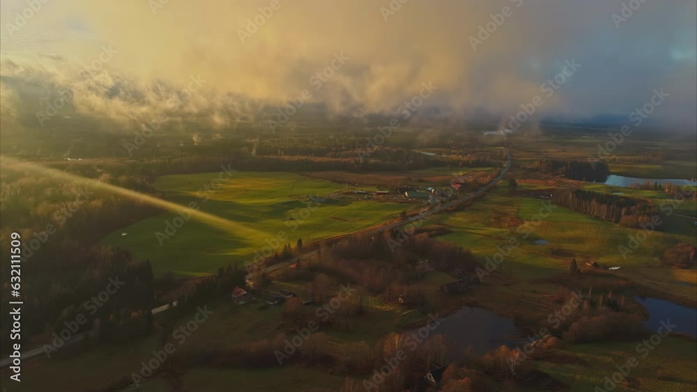 Aerial - Flight near clouds over lush green landscape at sunset. Forward drone Aerial - Flight near clouds over lush green landscape at sunset. Forward drone