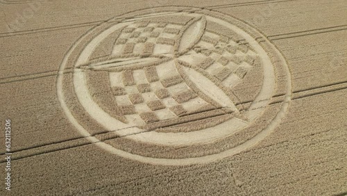 Establishing aerial view over South Wonston propeller crop circle to reveal golden Hampshire wheat field countryside photo