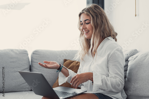 Portrait of young beautiful blonde girl talking with colleagues studying online in class room videocall learning. Working woman in a video conference..
