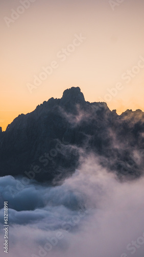 Mountain sunset with the peaks above the sea of clouds