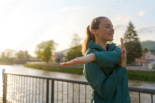 Attractive young woman stretching her arms before her early morning exercise