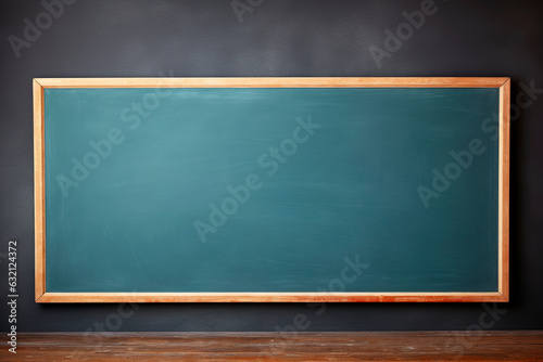 Empty green chalkboard with eraser and white chalk hang on the wall isolated on white background