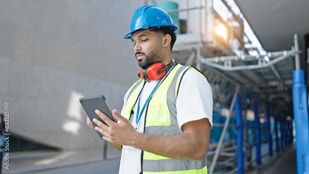 Fototapeta premium African american man builder using touchpad at street