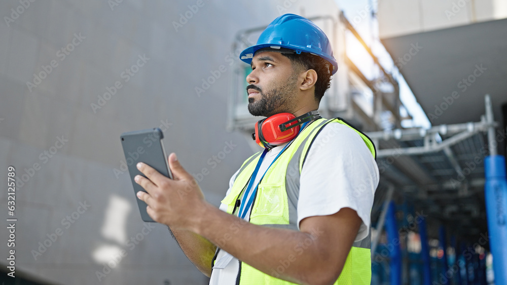 African american man builder using touchpad at street African american man builder using touchpad at street