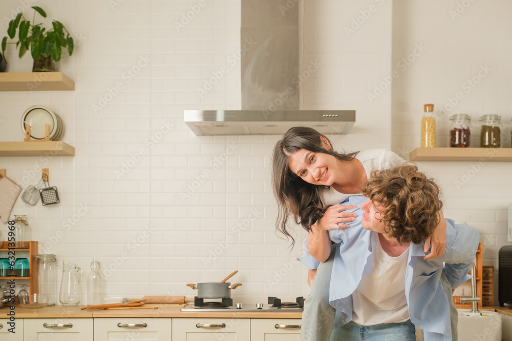 Romantic couple is cooking Handsome man and charming young woman are having while making salad, healthy lifestyle concept. Man girl standing in kitchen at home Spouses enjoy warm cooking process Romantic couple is cooking Handsome man and charming young woman are having while making salad, healthy lifestyle concept. Man girl standing in kitchen at home Spouses enjoy warm cooking process