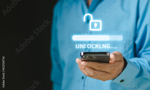 Businessman holding a smartphone unlock success idea, creativity concept, Hand holding unlock virtual icon graphic Business innovation and technology concept..