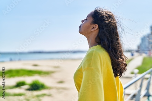 Young african american woman breathing at seaside photo