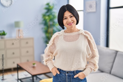 Young chinese woman smiling confident standing at home