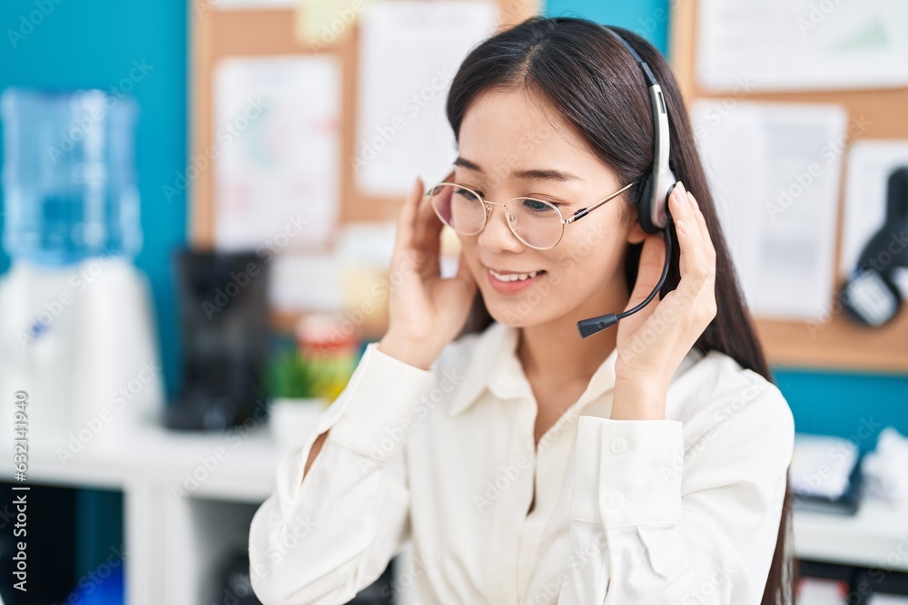 Young chinese woman call center agent smiling confident working at office Young chinese woman call center agent smiling confident working at office