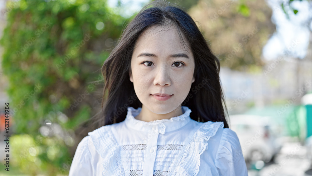 Young chinese woman smiling confident looking to the side at park Young chinese woman smiling confident looking to the side at park