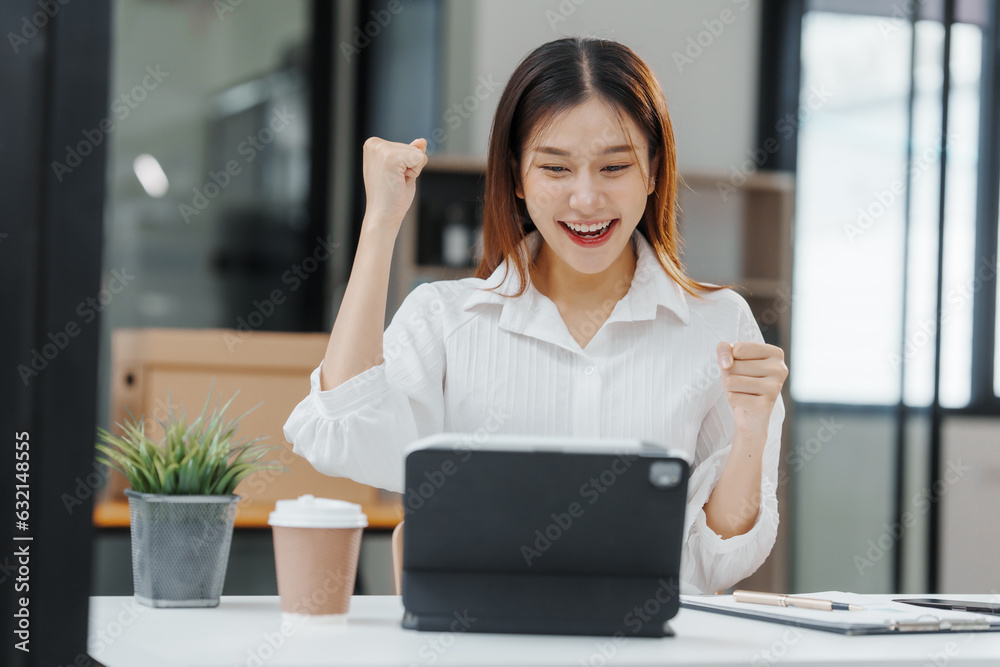 Excited Female secretary business woman in South Korean workplaces, feeling euphoric celebration online win success achievement result rejoicing over good news, raise up hands, good email news Excited Female secretary business woman in South Korean workplaces, feeling euphoric celebration online win success achievement result rejoicing over good news, raise up hands, good email news
