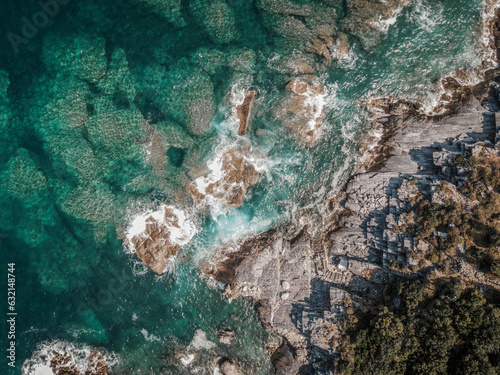 Fototapeta Naklejka Na Ścianę i Meble -  Drone top down aerial view of a beach with clear sea water and rocks at Mylopotamos Greece summer_2