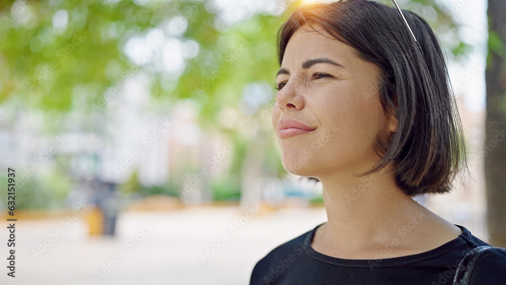 Young beautiful hispanic woman looking to the side with serious expression at park Young beautiful hispanic woman looking to the side with serious expression at park