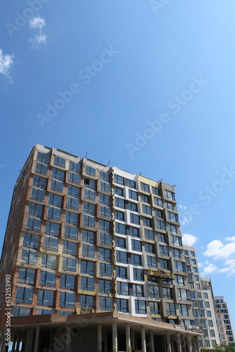 building in the city. new apartment buildings under construction with blue sky