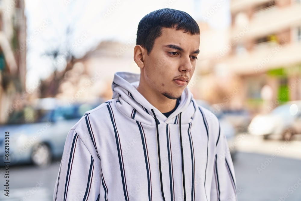 Fototapeta premium Young man with relaxed expression standing at street