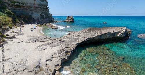 Fototapeta Naklejka Na Ścianę i Meble -  Aerial view of Petri i Mulinu beach and Skeleton Cave, Tropea, Calabria, Italy. Promontory overlooking the sea, panoramic view. Transparent sea