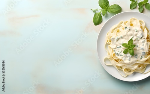 Pasta fettuccine alfredo with basil and fried chicken ham in creamy cheese sauce on a light stone, marble, modern pastel background, copyspace AI Generated  photo