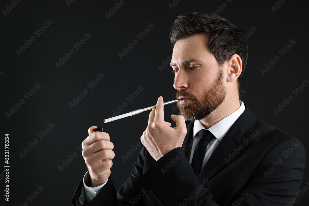 Man using long cigarette holder for smoking on black background, space for text Man using long cigarette holder for smoking on black background, space for text