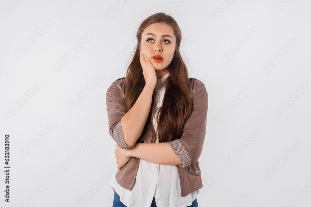 Young bored girl thinking about relationships, standing over white background. Young brunette woman wearing casual clothes thinking looking tired and bored with depression problems with crossed arms Young bored girl thinking about relationships, standing over white background. Young brunette woman wearing casual clothes thinking looking tired and bored with depression problems with crossed arms