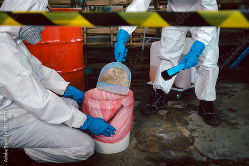 Clean up Chemical Liquid Spill. Scoop Materials into Toxic Waste Red Bag and Thick Plastic Barrels for Disposal, Dispose of Material Safely. Part of Basic Practical Training for Chemical Spill.