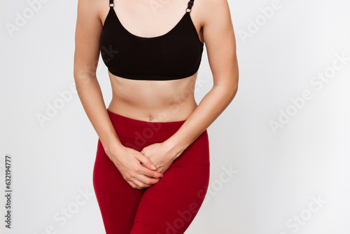 a young woman holding her hands to the bottom of the crotch. experiences unpleasant sensations and pain in the lower abdomen. Cystitis, urinary incontinence